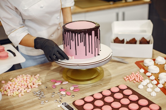 pink cake being decorated