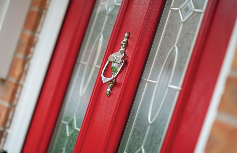 red composite door with a metal knocker