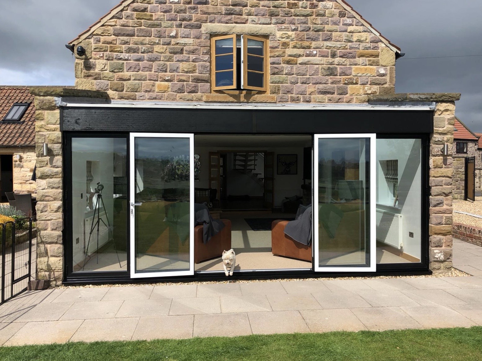black timber and uPVC and a white interior uPVC bifold door open