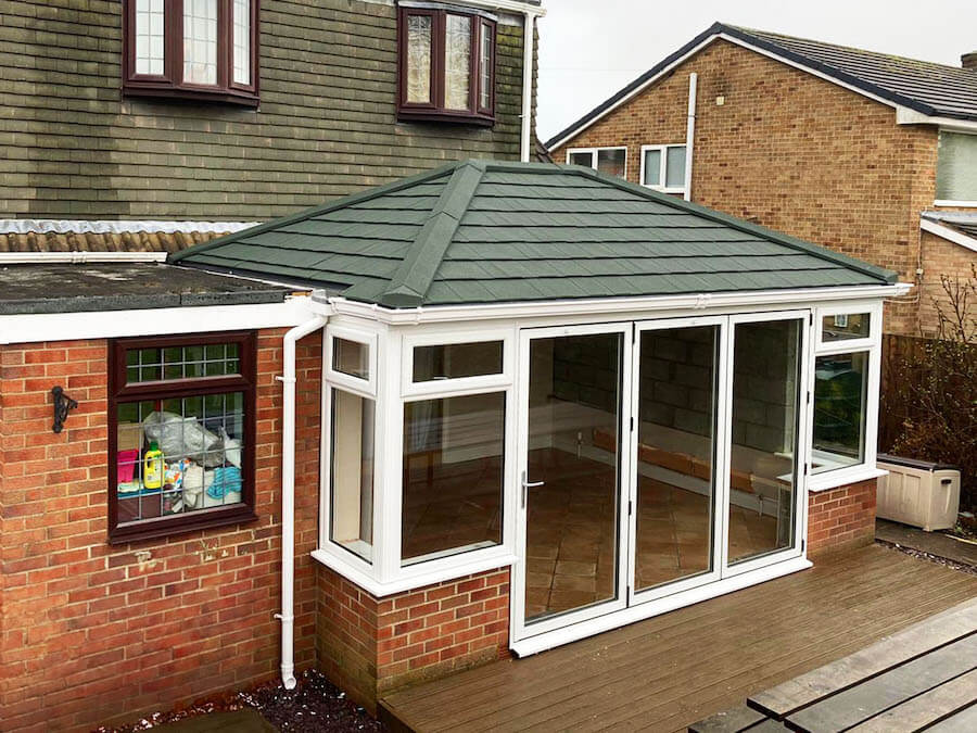White uPVC casement windows with a bi-fold door leading in to the conservatory.