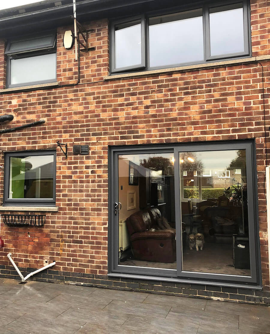 Black uPVC casement and fixed windows. Sliding black uPVC door.