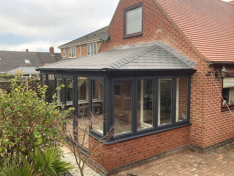 Black uPVC casement windows on a conservatory with a black slate roof