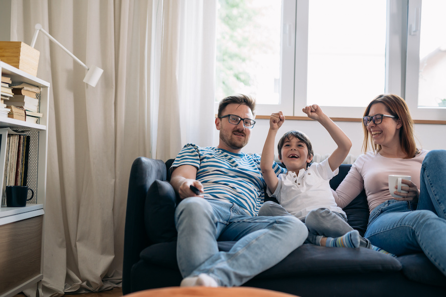family on a navy blue sofa