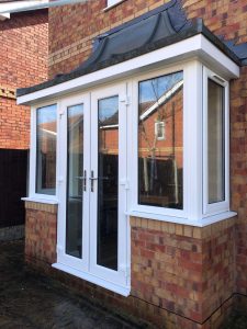 white upvc french doors under a slate roof